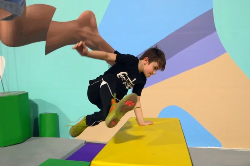 A young parkour student clearing an obstacle at LVCC
